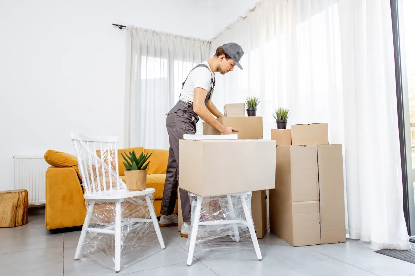 Mover packing boxes in a bright room
