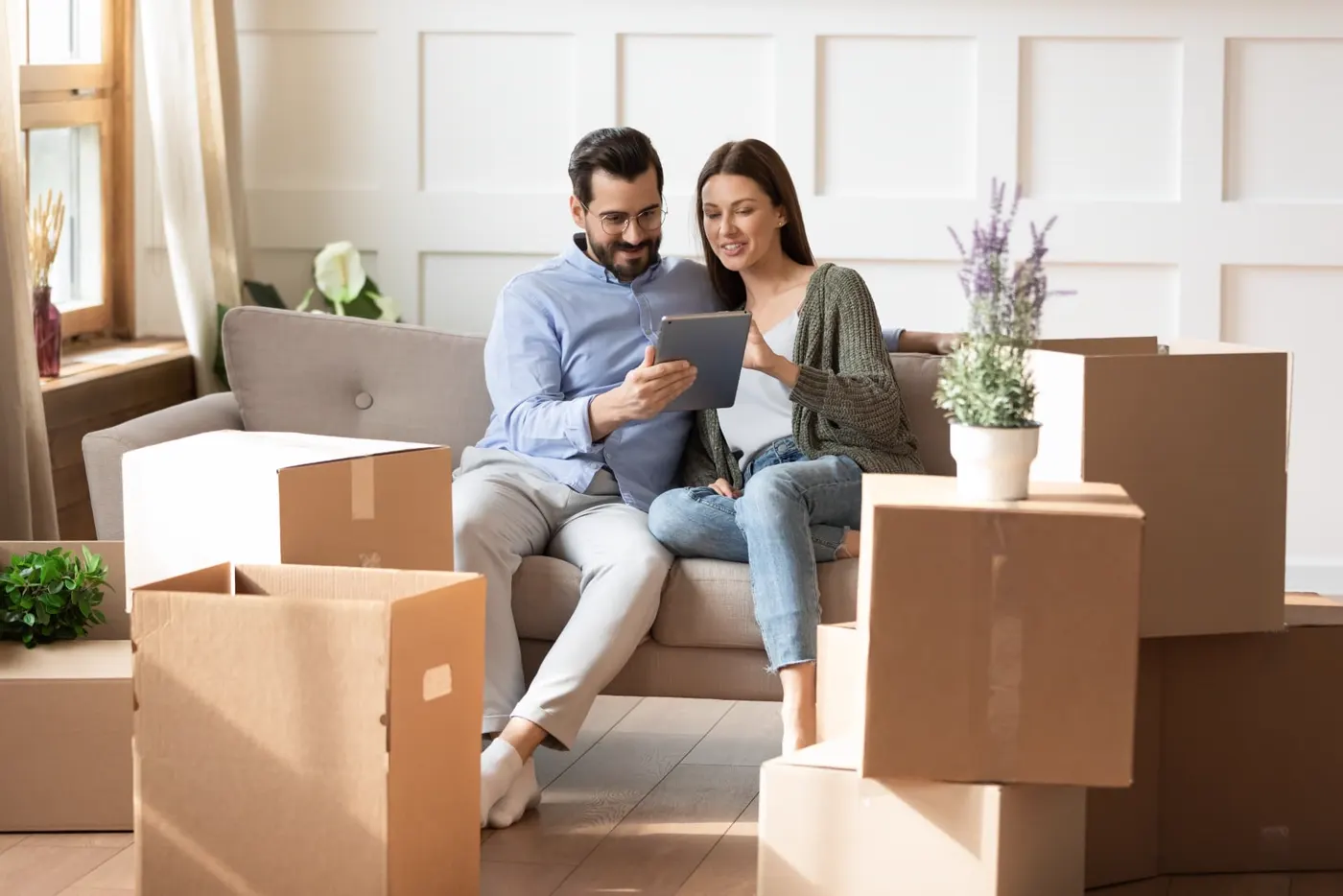 Couple on a sofa surrounded by moving boxes